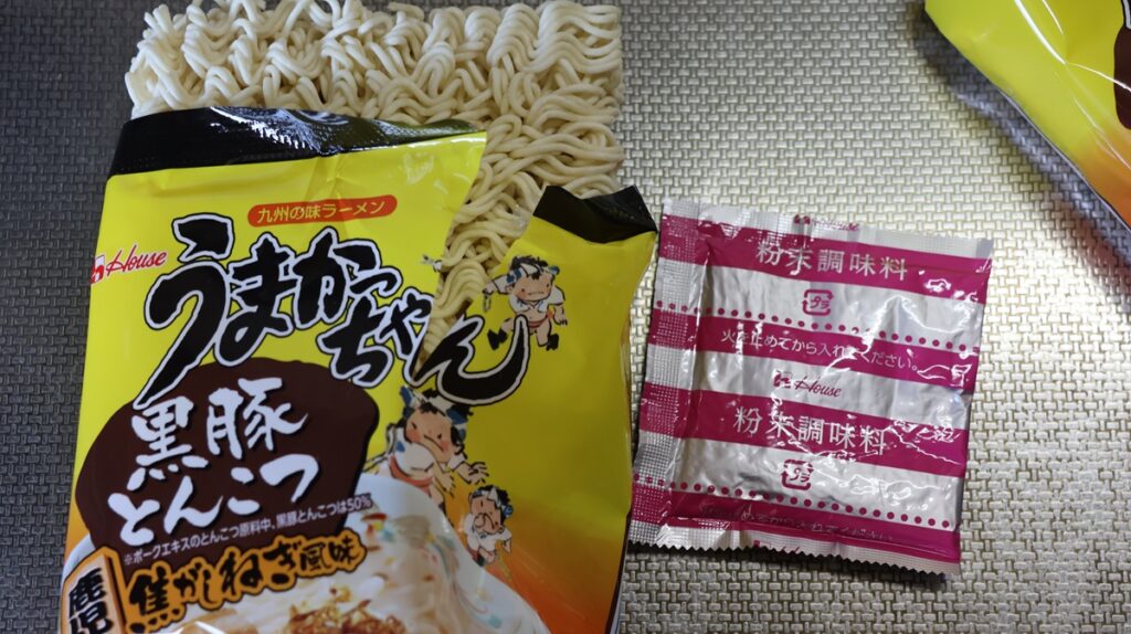 うまかっちゃん黒豚とんこつの内容物である麺と粉末調味料を映しています